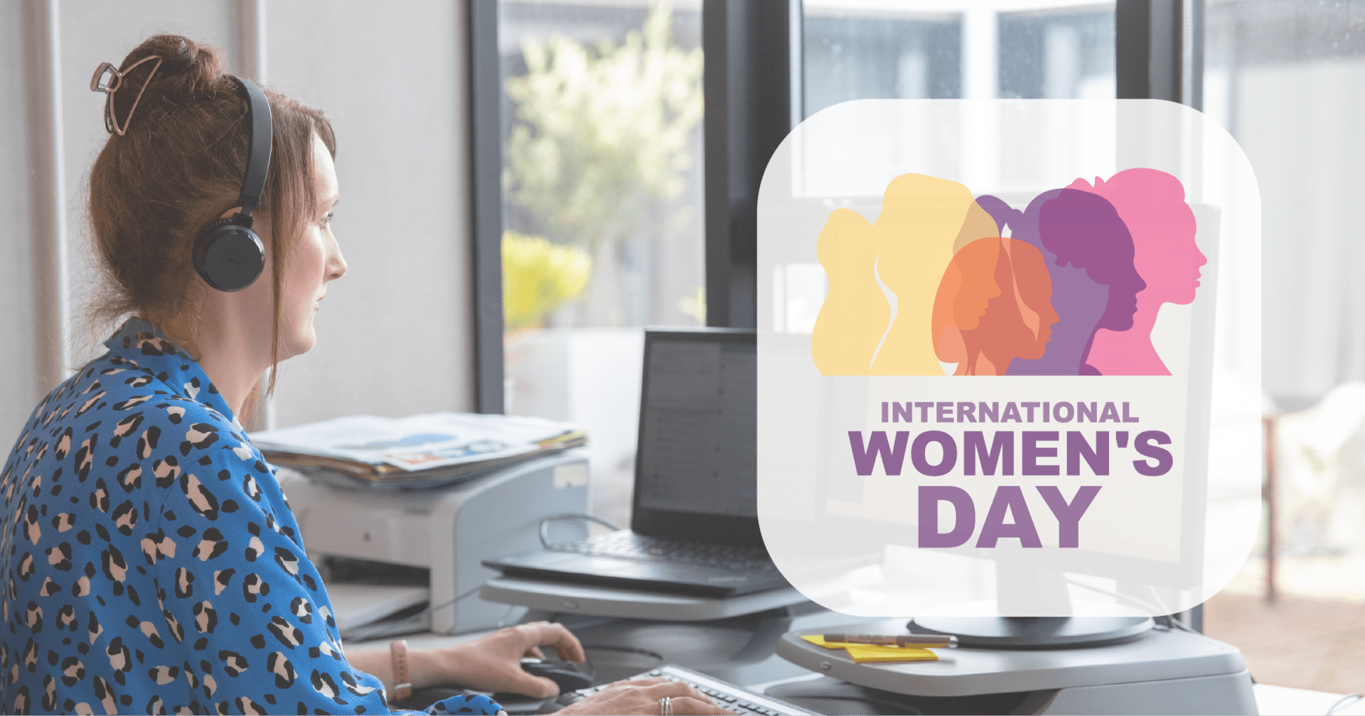 Woman working at desk with International Women’s Day 2024 graphic beside her.