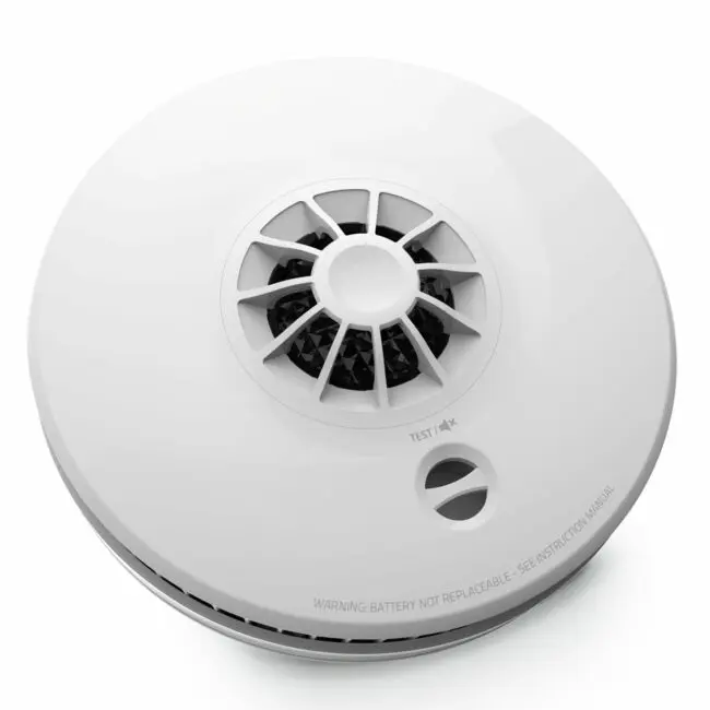 The HM-SN-1 is a round white smoke detector with vents and a test button on its surface.