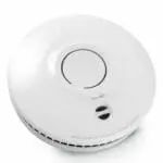 SM-SN-1 round white smoke detector with central test button and vented edge.