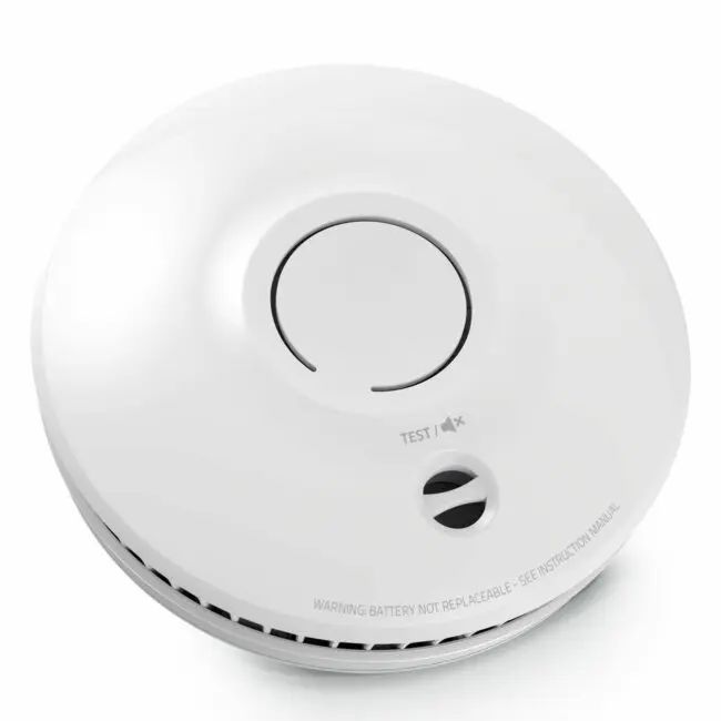SM-SN-1 round white smoke detector with central test button and vented edge.