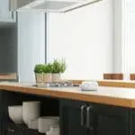Modern kitchen with herbs in pots and FA3313x4 on a wooden worktop.