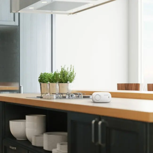Modern kitchen with herbs in pots and FA3313x4 on a wooden worktop.
