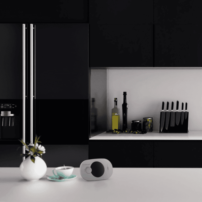Modern black kitchen with knives, olive oil, and the FA3322 vase on the worktop.