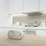 The FA3820X4 carbon monoxide alarm sits on a wooden worktop in a modern white kitchen.
