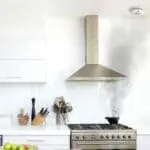 Black smoke rises from an FP1740W2-R pot on a hob in a bright modern kitchen.