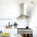 A FS1226-T kettle is producing smoke on a hob in a modern white kitchen.