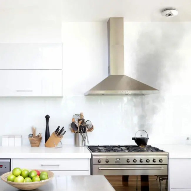 A FS1226-T kettle is producing smoke on a hob in a modern white kitchen.