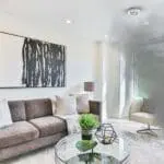 Modern living room with smoke from the window and an FS2126-T smoke detector on the ceiling.