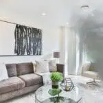 SM-SN-1 smoke fills a modern living room with a sofa and large abstract painting.