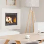Modern living room with FA3313-EUX10 on a wooden table next to white furniture.