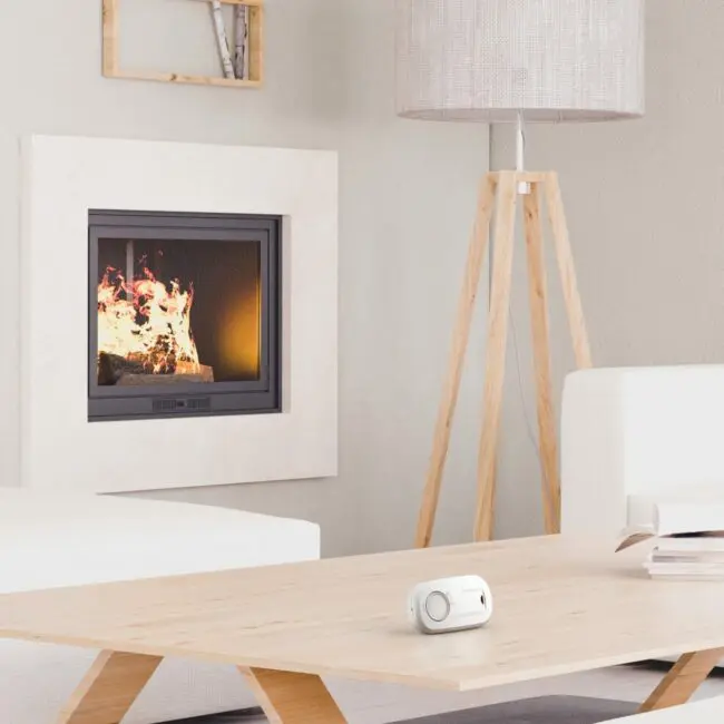 Modern living room with FA3313-EUX10 on a wooden table next to white furniture.