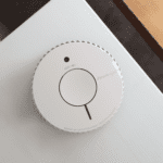 FA6620-R smoke detector mounted on a white ceiling near a wooden surface.