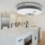 FP1740W2-R smoke detector installed on the ceiling of a modern white kitchen.