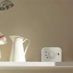 FP1820W2-R gas detector on a kitchen shelf beside a white jug and towel.
