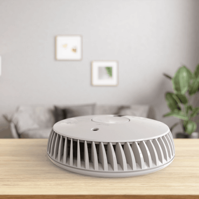 The FA6611-R air purifier sits on a wooden table in a modern living room.