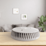 The FA6620-R air purifier sits on a wooden table in a cosy living room.