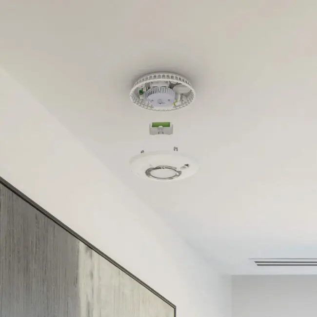 FS2126-T smoke detector with cover removed, mounted on a white indoor ceiling.