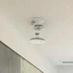 The FP1640W2-R smoke detector hangs open, exposing its internal wiring and parts.