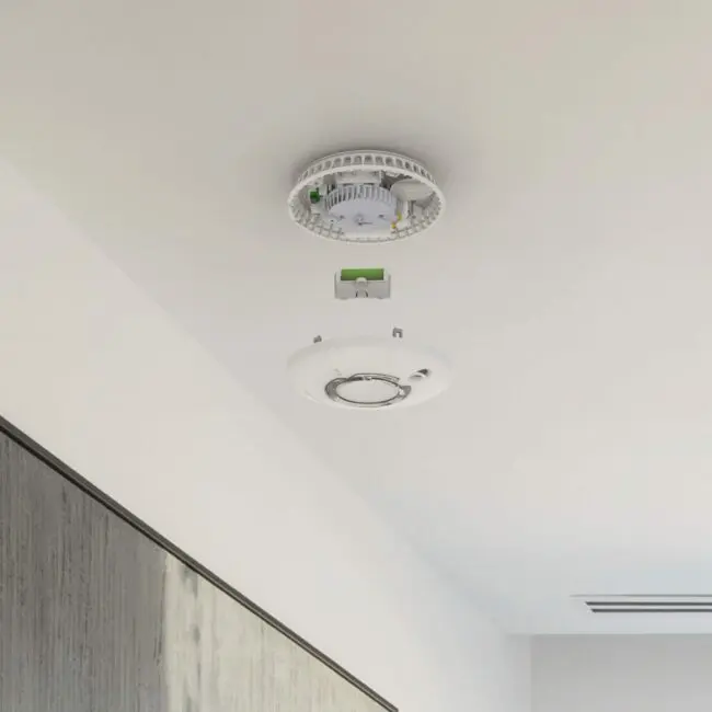 FP2620W2-R smoke detector with cover removed, exposing wiring on a white ceiling.