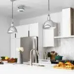 Modern white kitchen featuring the FireAngel HT-630 and stainless steel appliances with pendants.