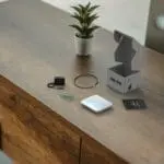 FP1000W2-R gadget kit and a small plant on a wooden table.