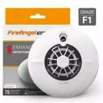 Round white FS1226-T smoke alarm in front of FireAngel GRADE F1 packaging.