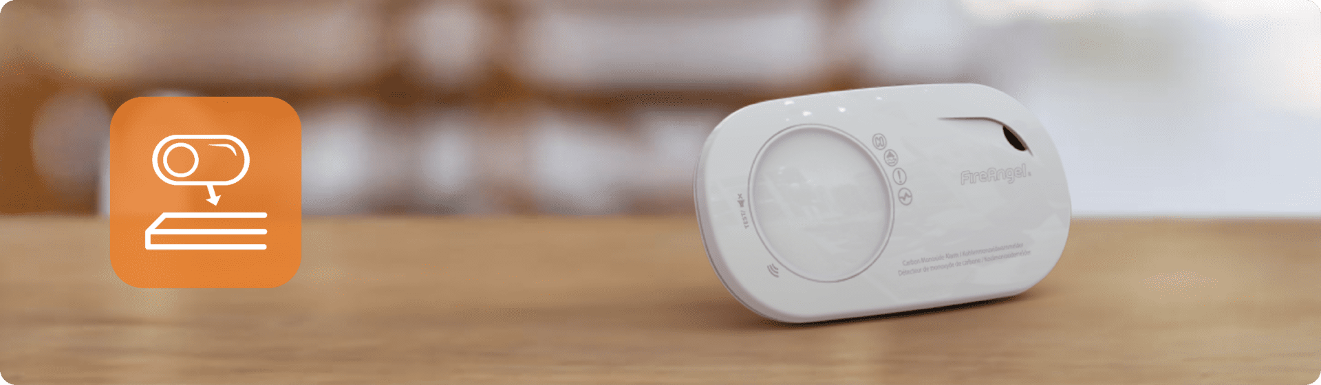White Sync‑It smart sensor device on wooden surface with orange icon showing device placement.
