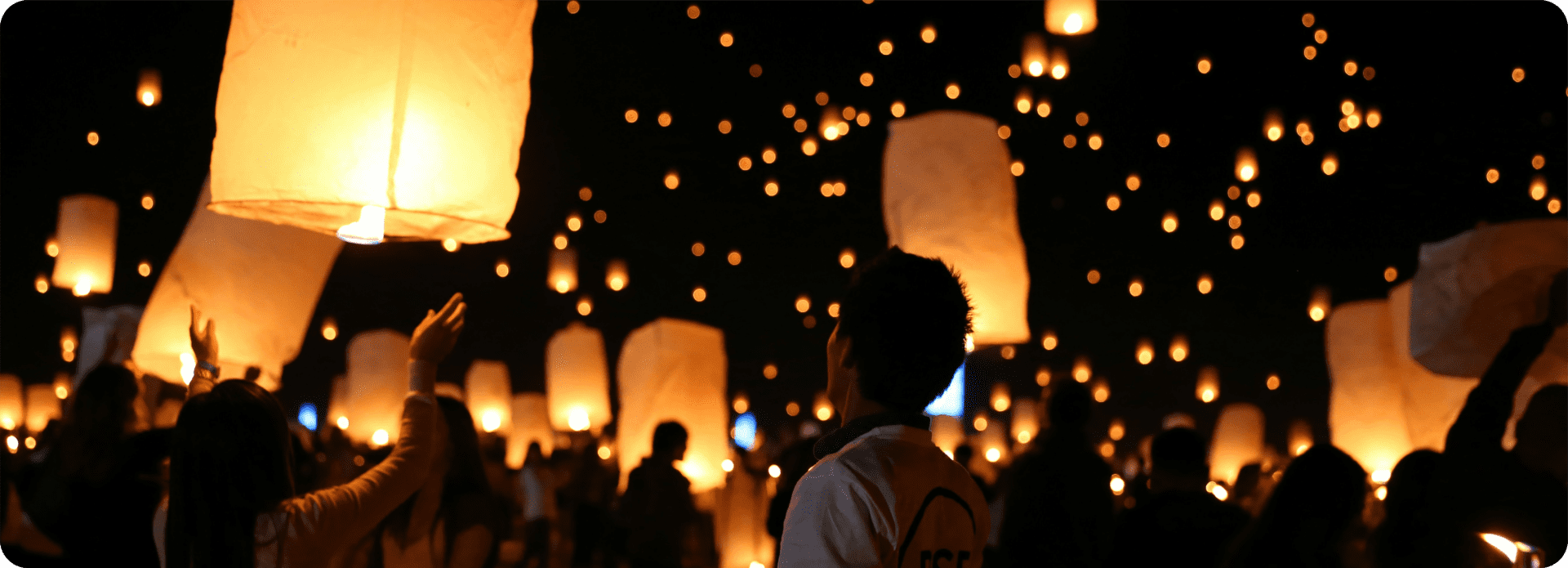 People release glowing lanterns into the night sky during a lantern festival for Chinese New Year.