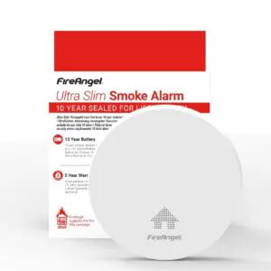 White FA6829S smoke alarm with slim CO alarm and red and white packaging in the background.