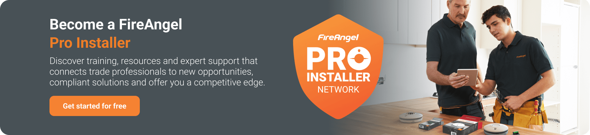 Two men review a tablet in a kitchen, exploring FireAngel Pro Installer design service options.