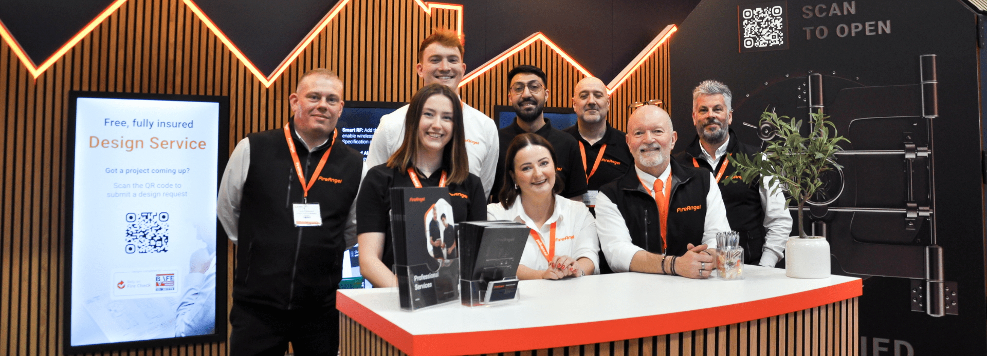 Eight smiling people stand at a FireAngel exhibition stand at the Fire Safety Event 2026. From let to right, back row to front:
David Cunningham, Daniel Grimsdell, Reji Chohan, Paul Whitehouse, Nick Atkinson
Emily Dawson, Bethan Ford, Andy Ball