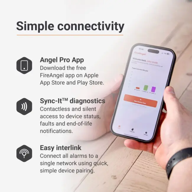 Person holds phone with SP540 app, showing diagnostics for Spec+ Multi-Sensor Smoke/CO Alarm.