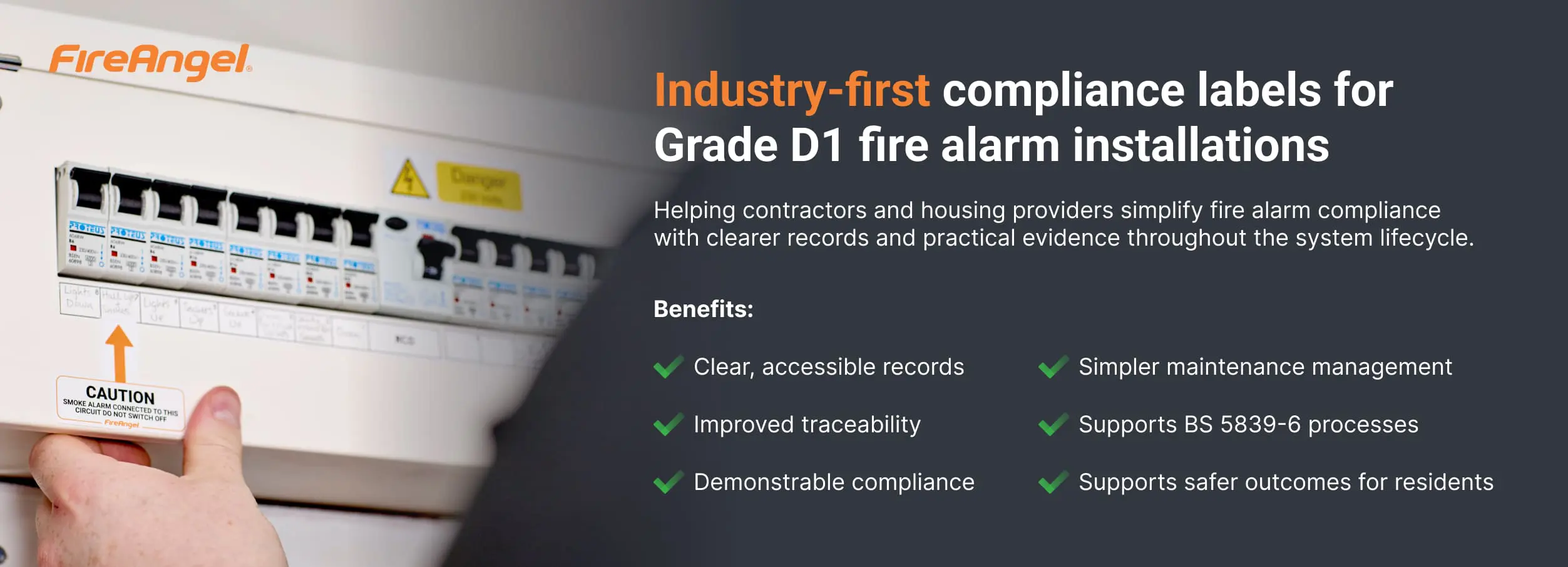 Person filling out a fire alarm compliance label on a white fuse box for safer buildings.
