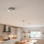 FA8720BW-R smoke detector on a kitchen ceiling with white cupboards and lights.